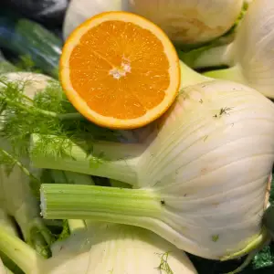 Whole fresh fennel and halved oranges at Earth Markets, showing the perfect pairing for Sicilian fennel and orange salad