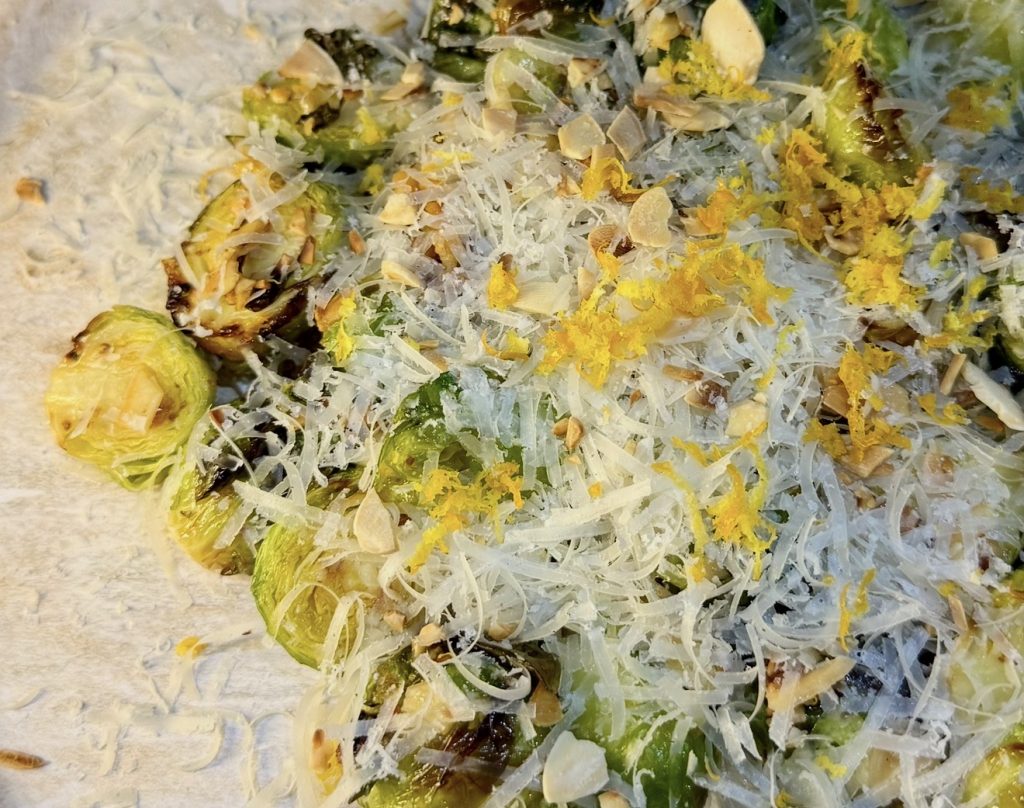 Air fryer Brussels sprouts with hot honey, orange zest, toasted almonds and grated Grana Padano